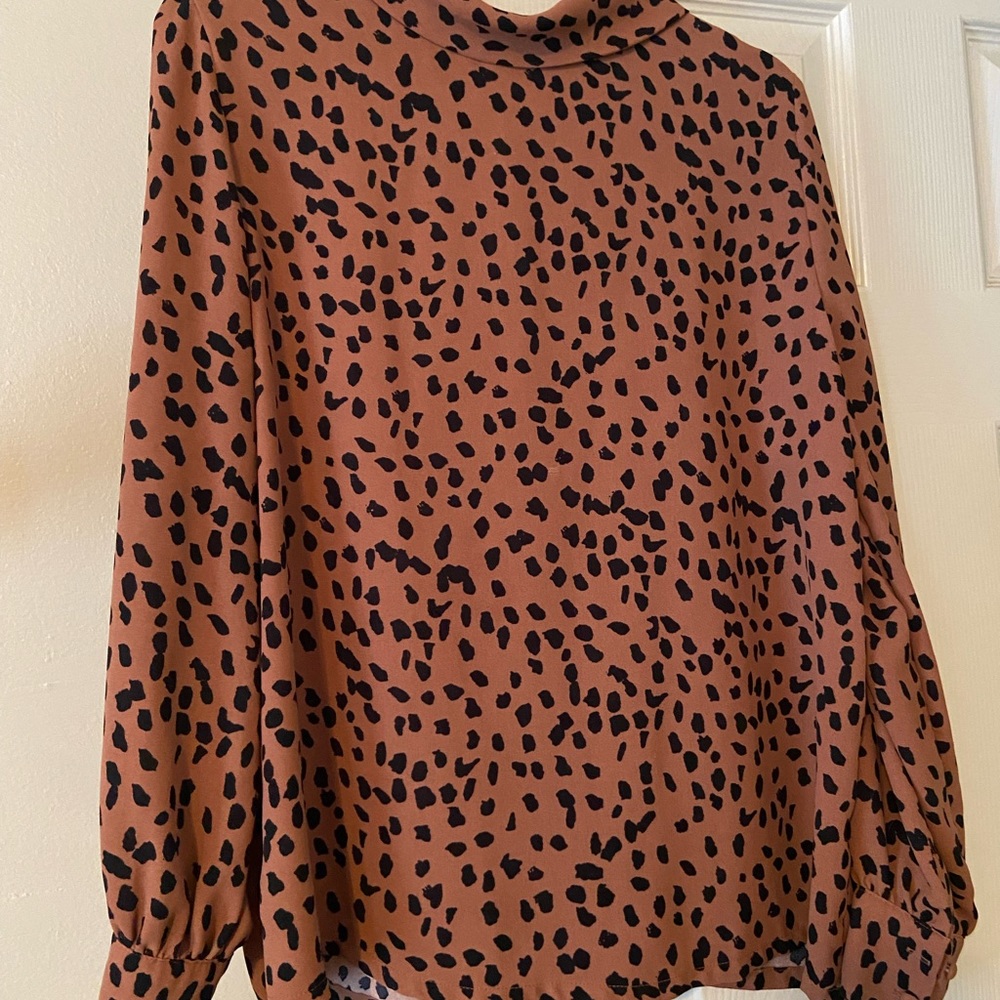 Women’s long sleeve animal print blouse.